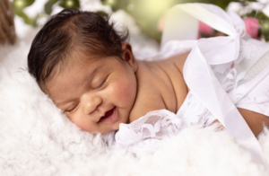 Newborn family photoshoot with baby in styled setup using props and outfits