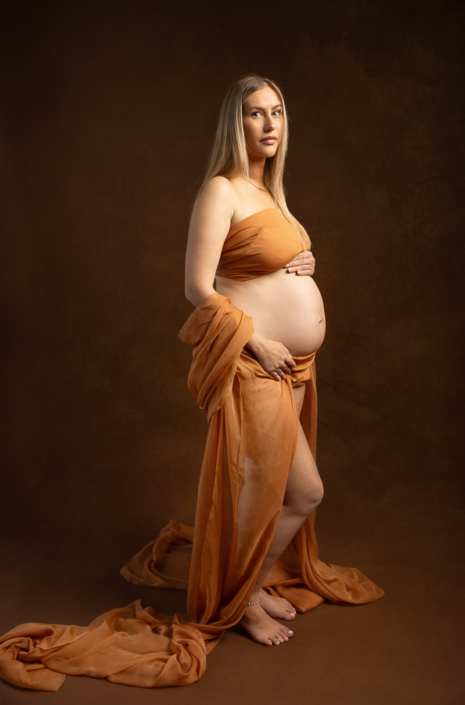 Vintage-inspired orange fabric maternity photoshoot – Sharjah maternity photographer | Arpna Photography