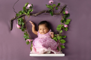 Newborn baby photographed at home with family in a relaxed lifestyle setting