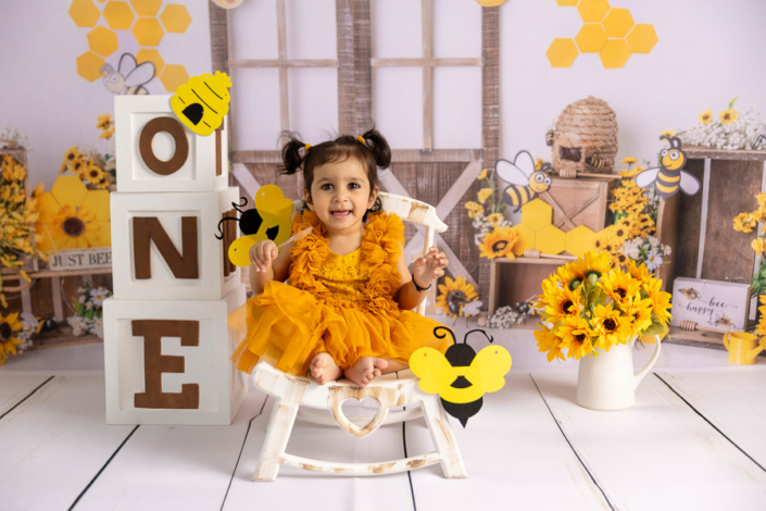 Outdoor Bee-Themed First Birthday Photoshoot | Arpna Photography UAE Outdoor bee-themed first birthday cake smash by Arpna Photography UAE