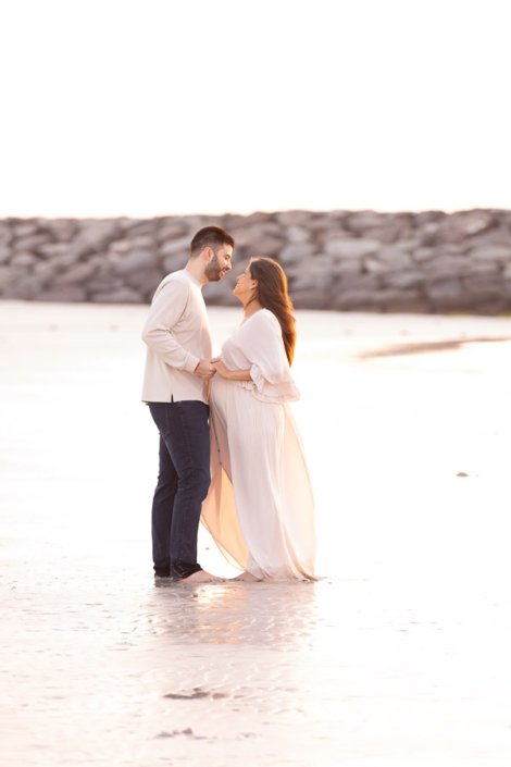 Natural barefoot maternity shoot at Dubai beach during sunset