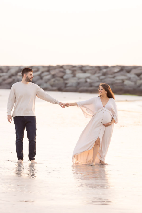 Romantic couple maternity photoshoot at JBR Beach Dubai during golden hour