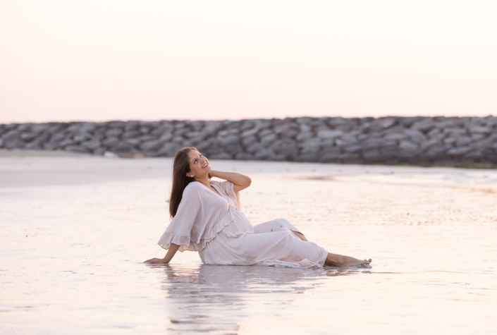 Dubai beach maternity photoshoot at La Mer Beach during golden hour with flowing dress