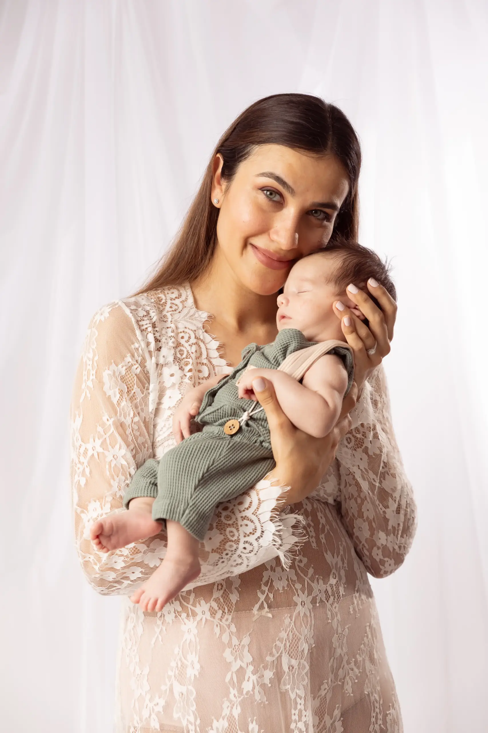 Mother holding newborn baby with a newborn photographer in Dubai