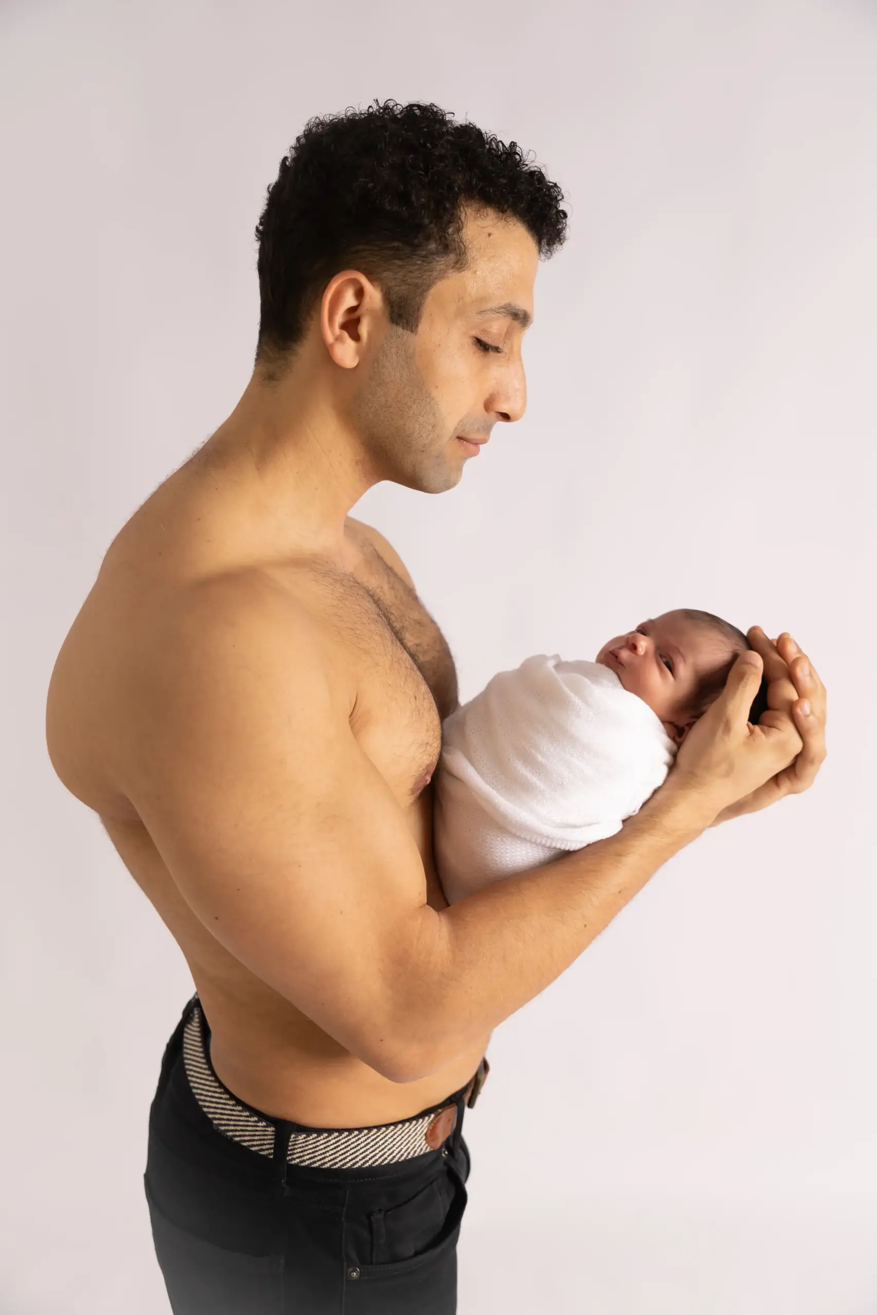 Father holding newborn baby during a Dubai newborn photography session