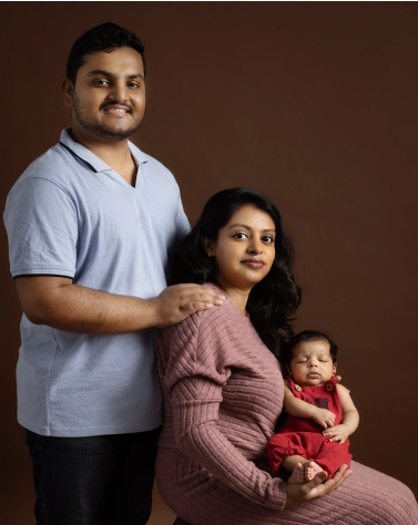 Parents holding newborn baby during newborn photography in Dubai