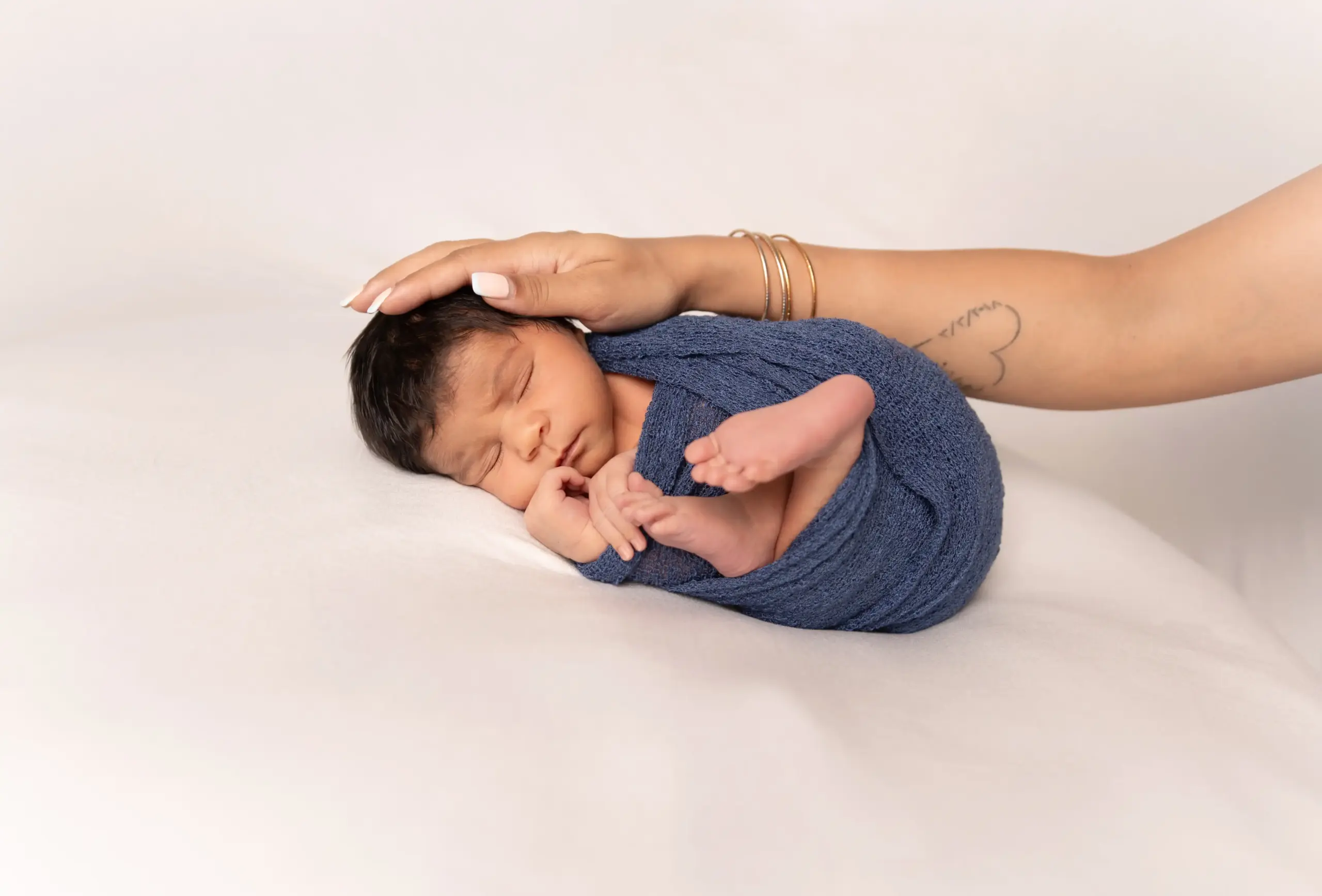 Mother with newborn baby during newborn photography in Dubai
