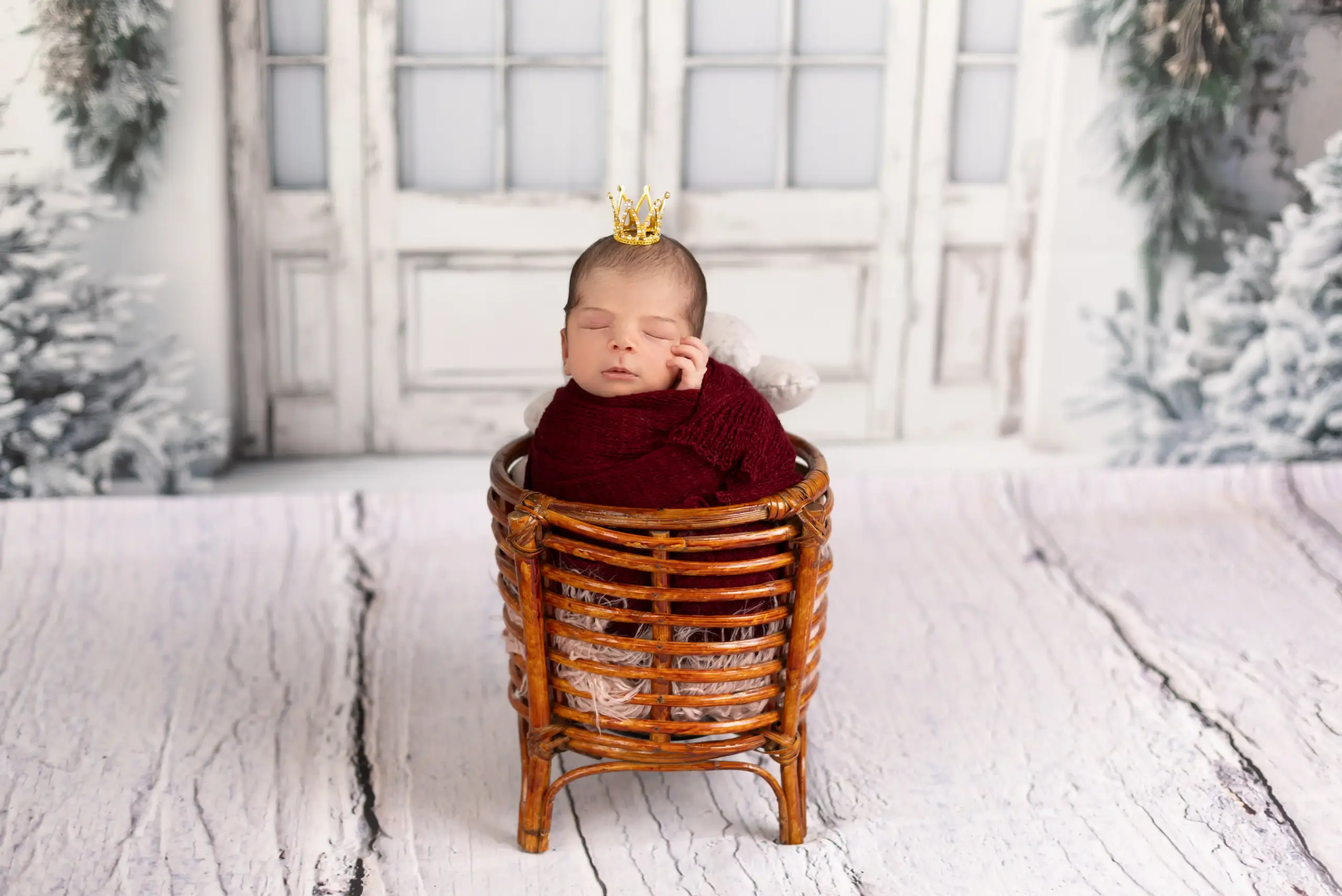 Newborn baby sleeping in a decorative basket during newborn photography in Dubai